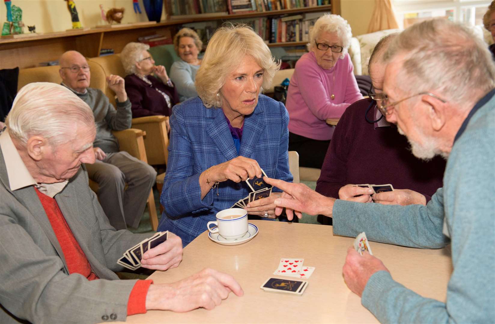 Camilla plays cards with visitors to Fair Close Day Centre