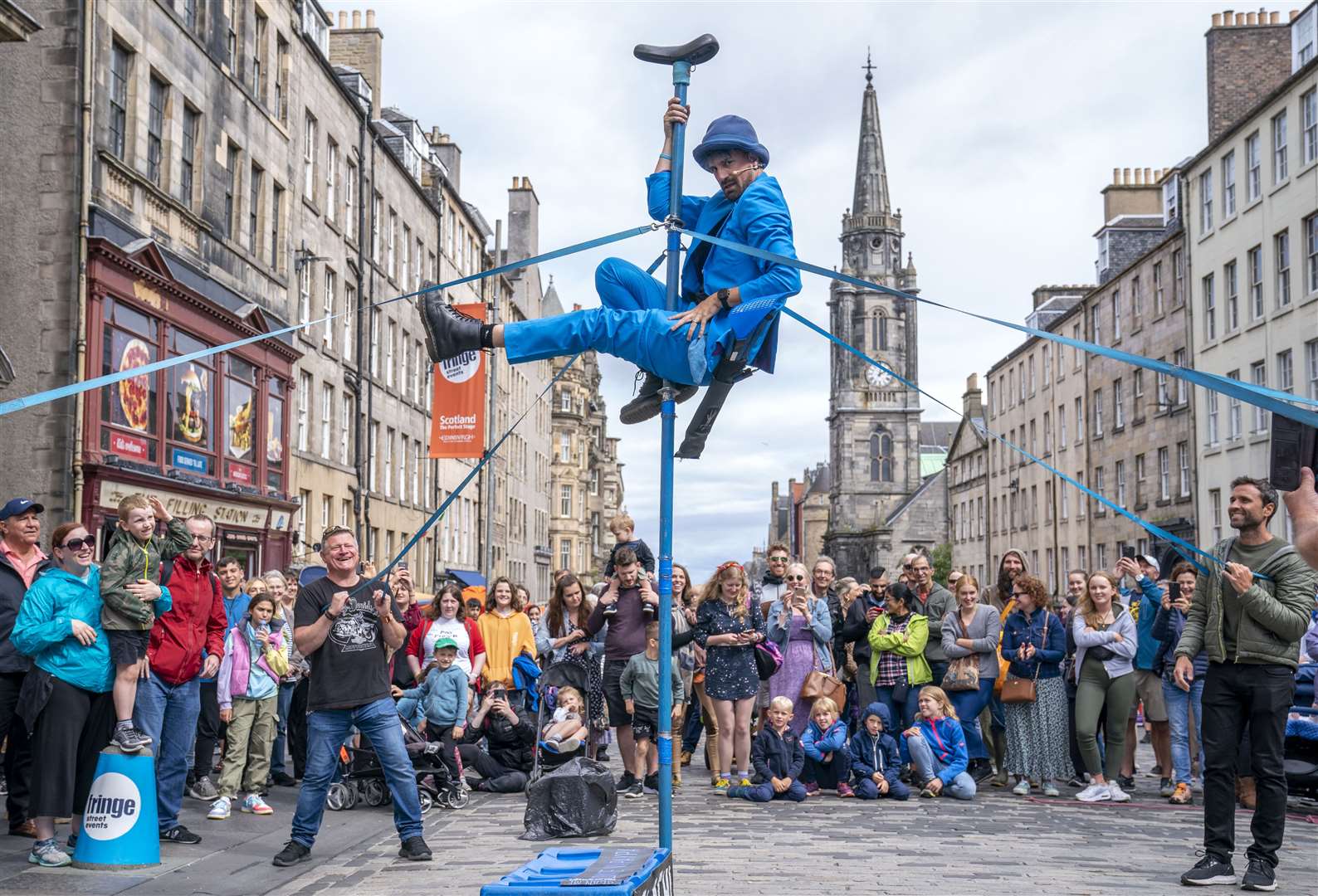 A street performer entertains the crowds on Edinburgh’s Royal Mile as part of the Fringe (PA)