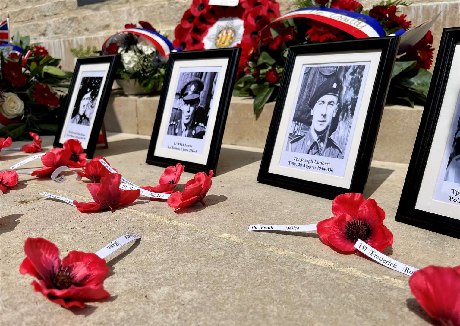 Photos of Cecil's fallen comrades laid at the 4th/7th Royal Dragoon Guards Memorial in Creully. Credit: Mirek Gosney