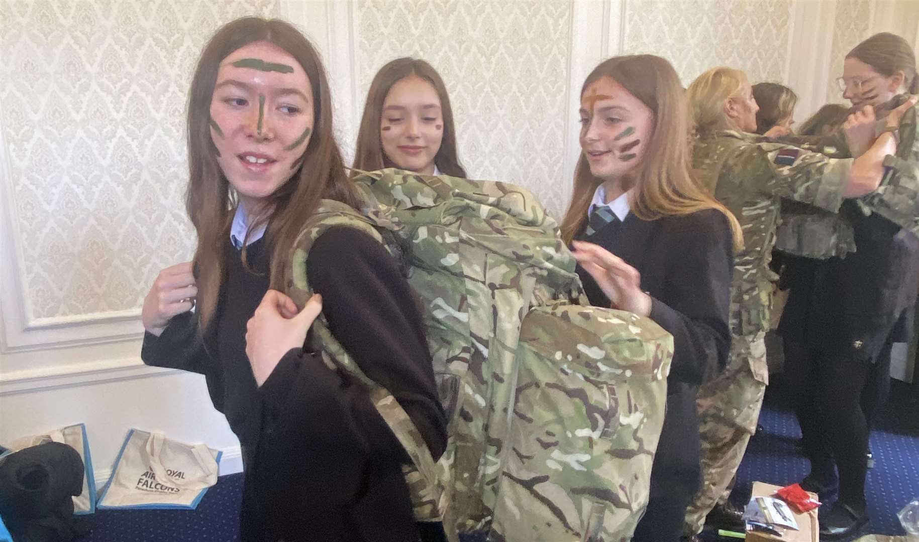 Year 8 girls trying on military gear. Credit: The Downs School