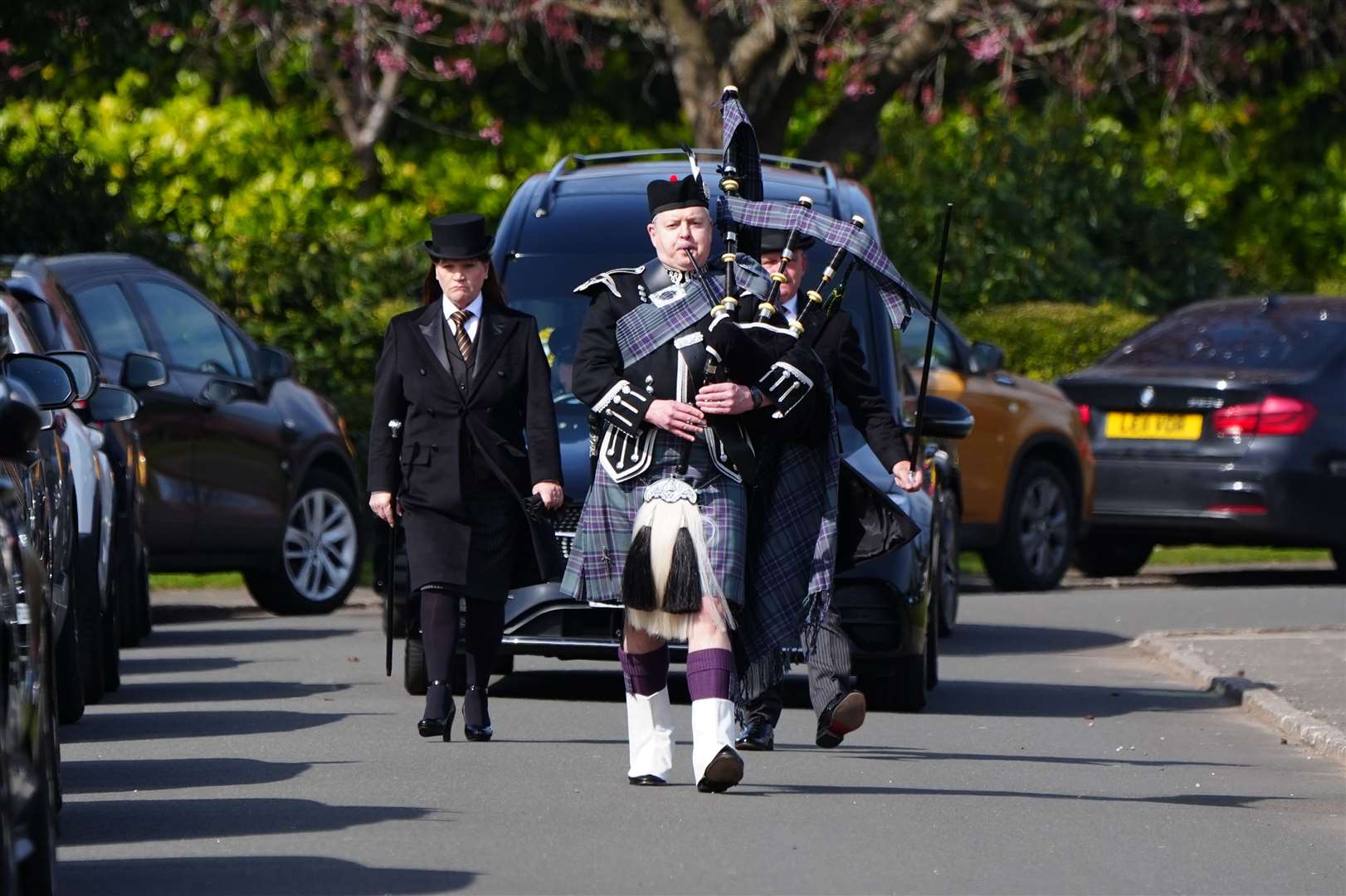 A piper leads the cortege at the funeral (Jane Barlow/PA)