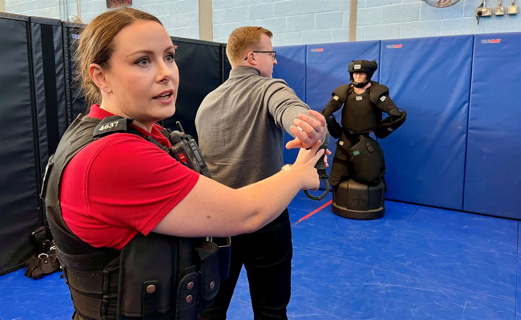 PC Nikki Pearce demonstrating how to correctly apply handcuffs to a suspect