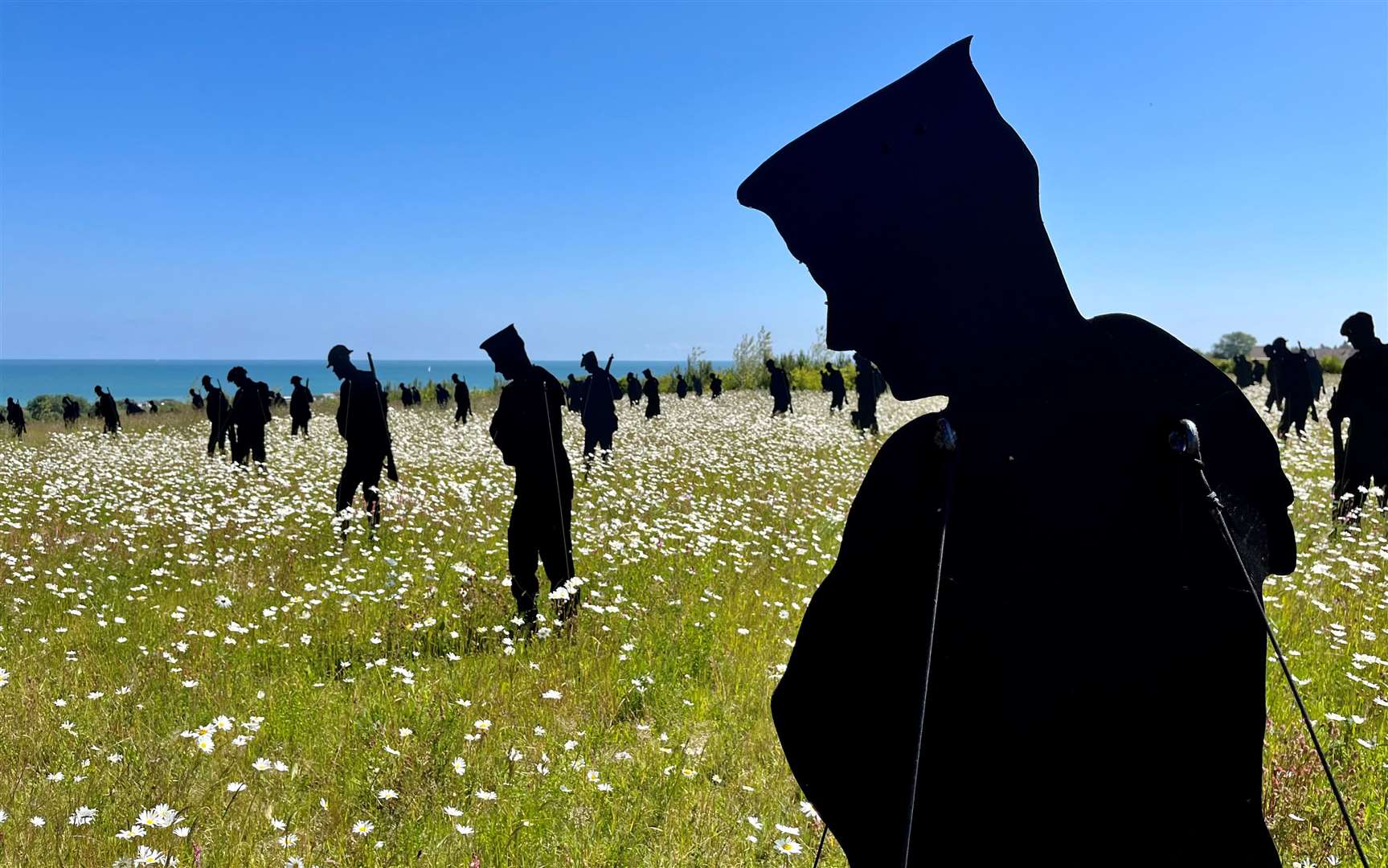 A total of 1,475 silhouettes standing in the fields at Ver-sur-Mer. Credit: Mirek Gosney
