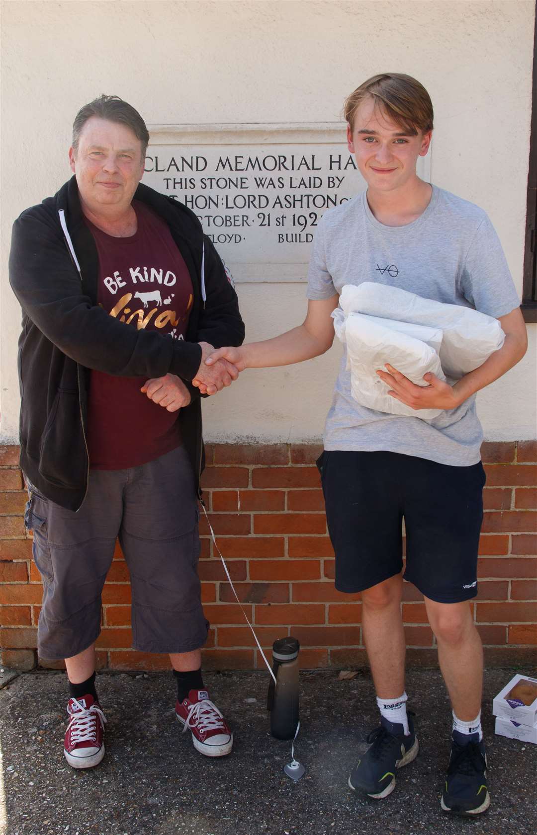 Henry Read-Denness receives gifts from Viva! local contact Mike Busby