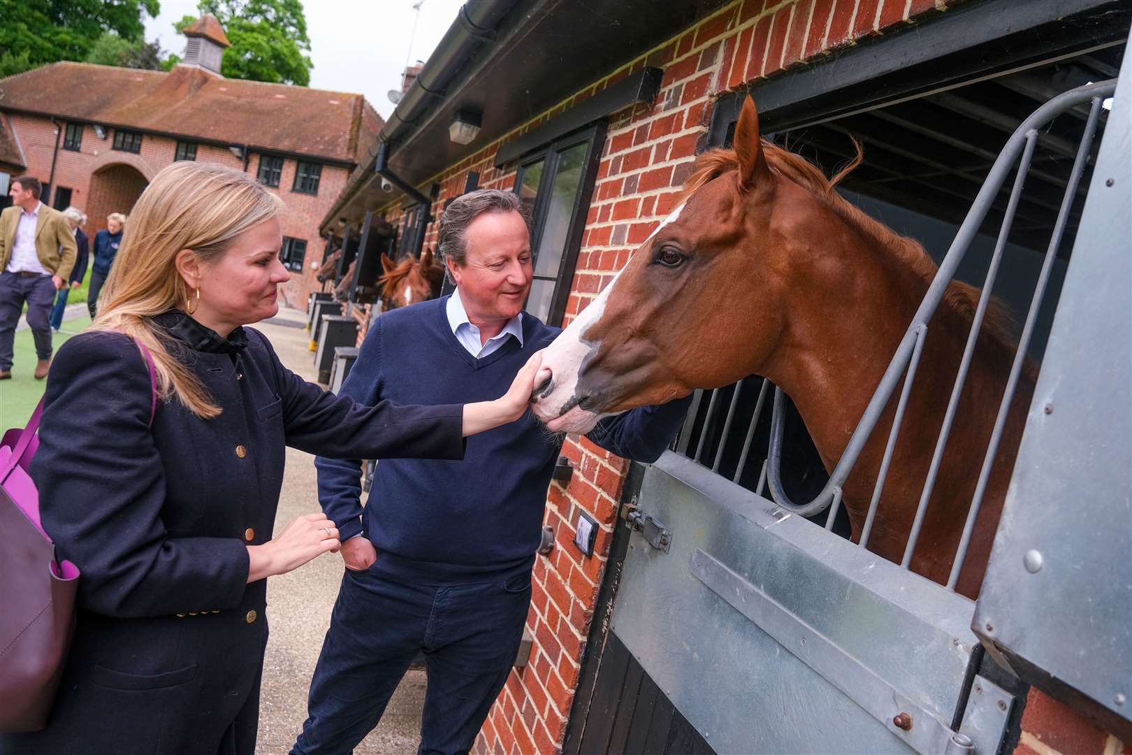 Lord Cameron and Laura Farris meeting the horses at Ed Walker’s yard