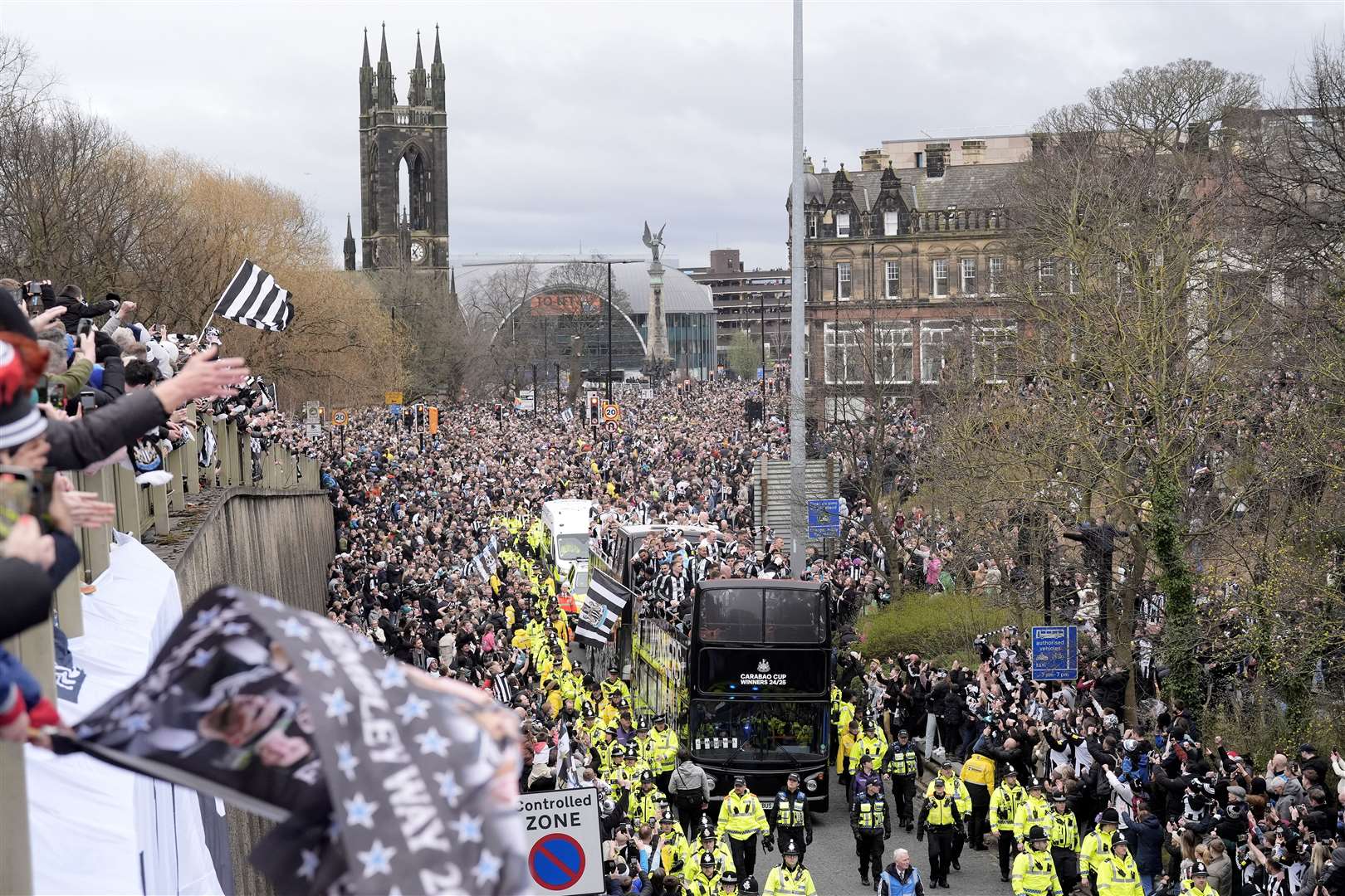 Newcastle United fans watch on as the players pass by aboard an open top bus during the Carabao Cup trophy parade (Danny Lawson/PA)