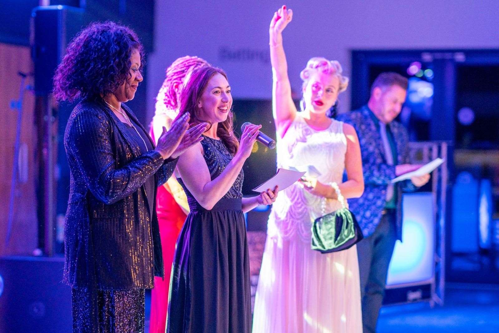 A number of neonatal nurses give a speech during the evening