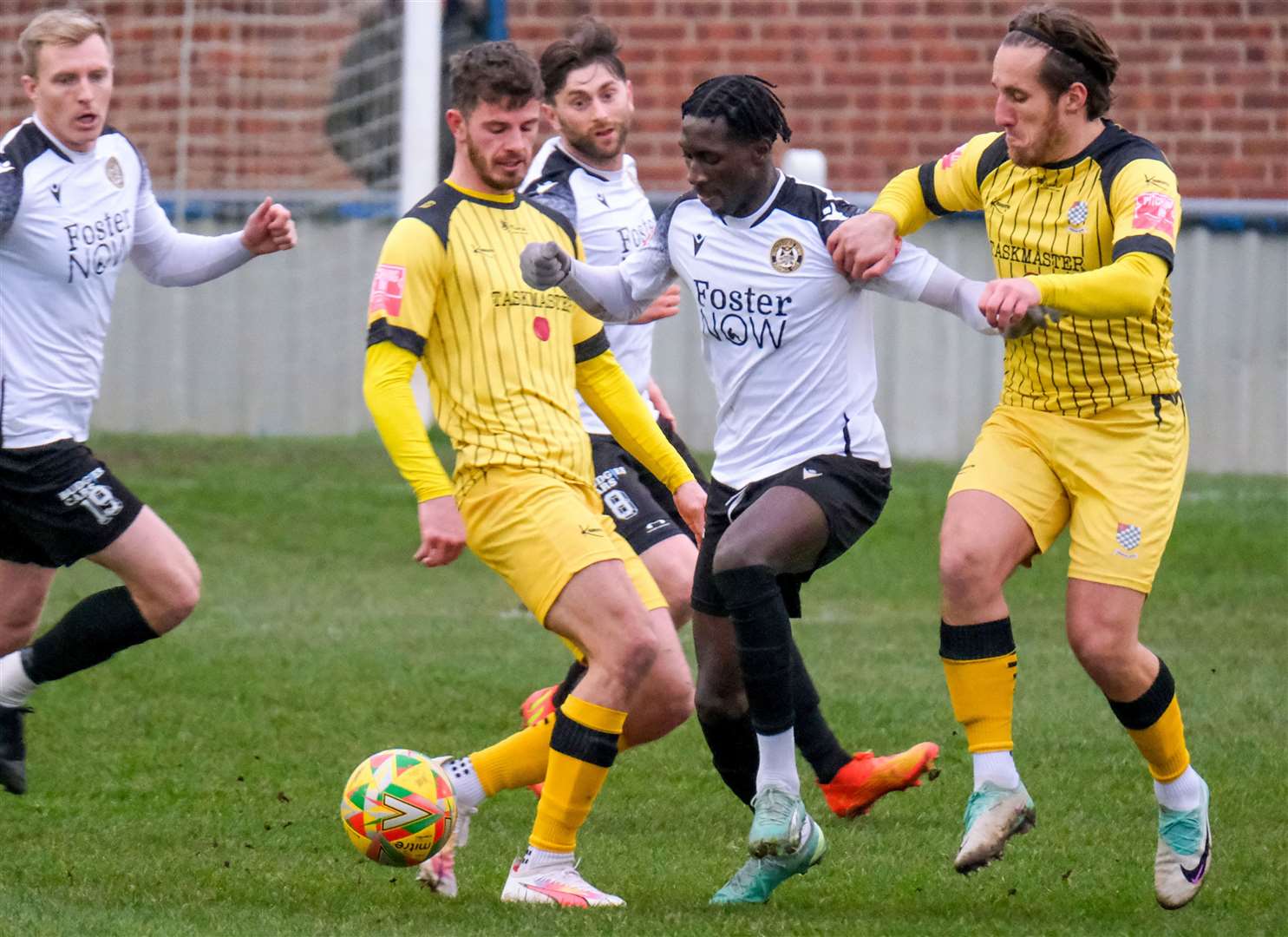 Cheltenham Town loanee Adulai Sambu receives some close attention from Lewis Rolfe