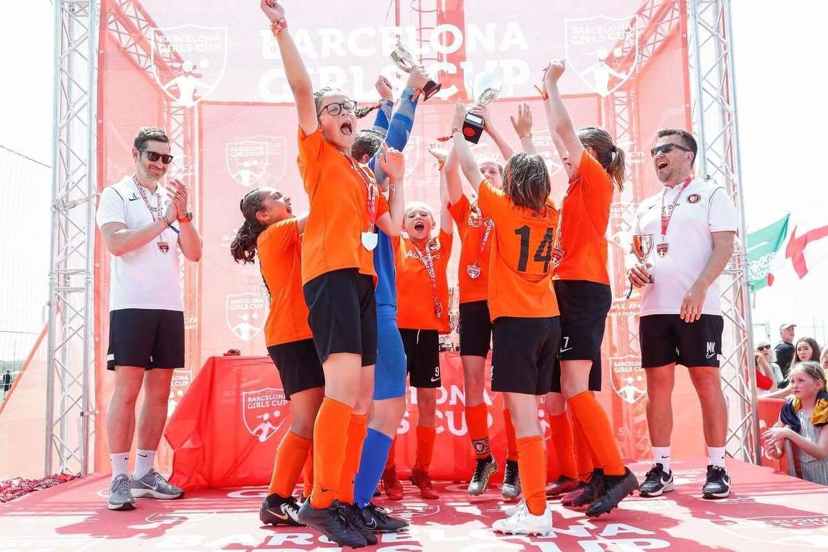 Newbury District PSFA Girls celebrate following the Barcelona Girls Cup