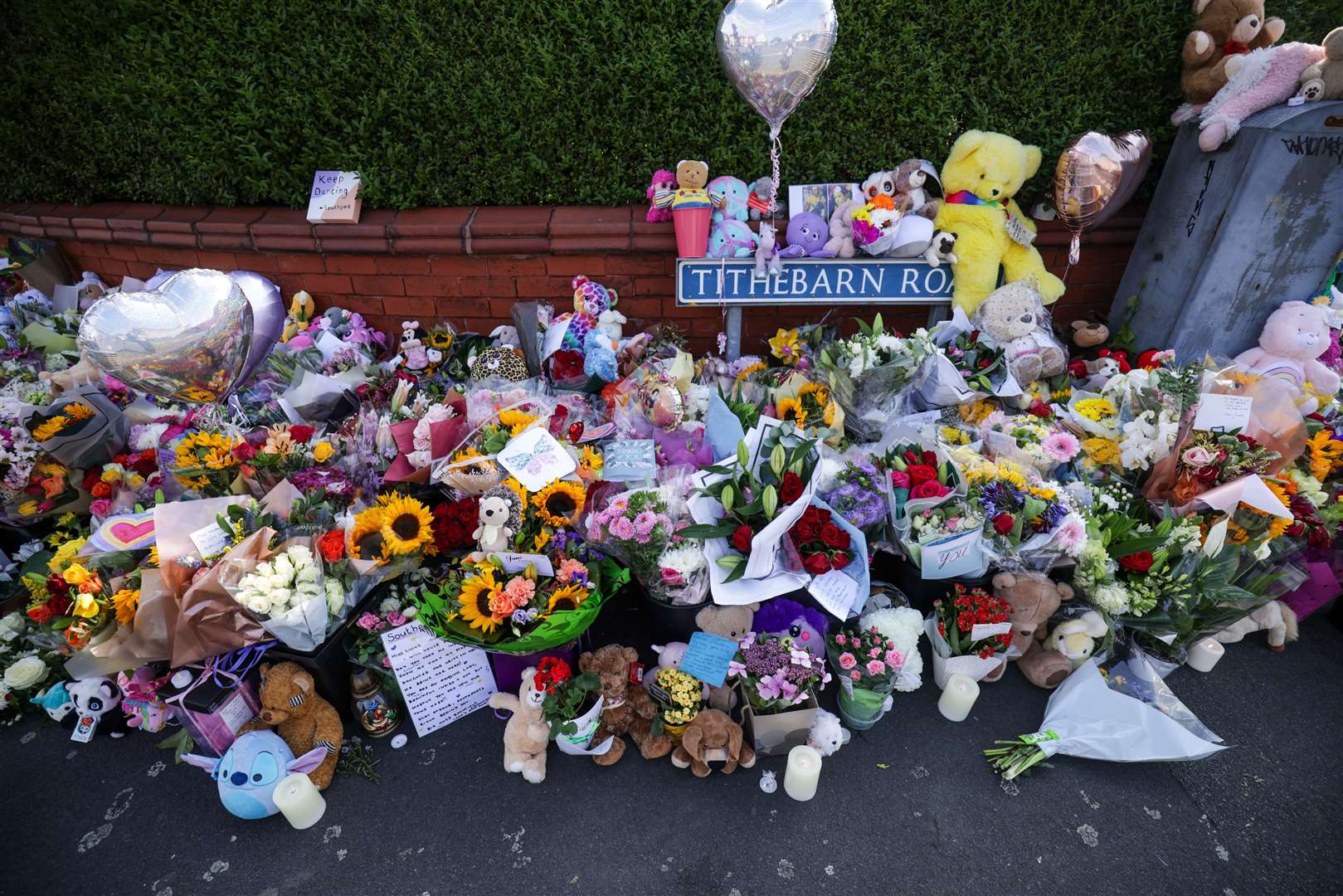Floral tributes on the junction of Tithebarn Road and Hart Street in Southport, following the attack (James Speakman/PA)