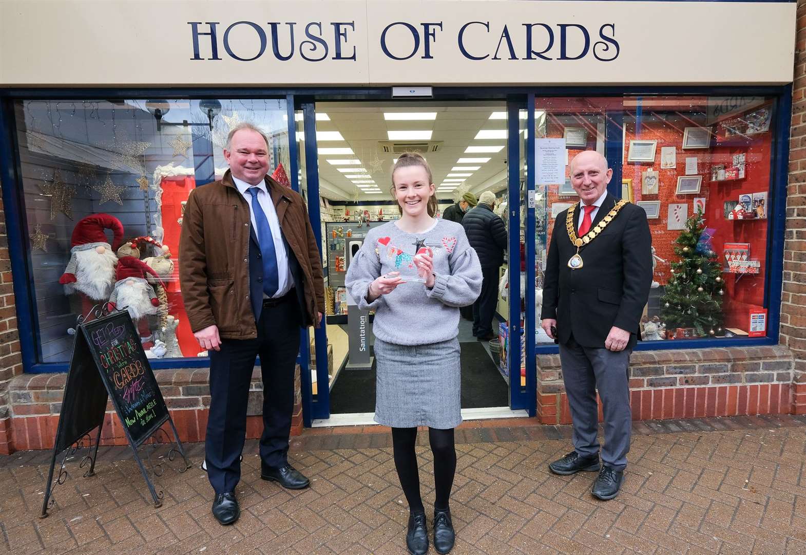 House of cards in Thatcham being presented with the best dressed Christmas window.