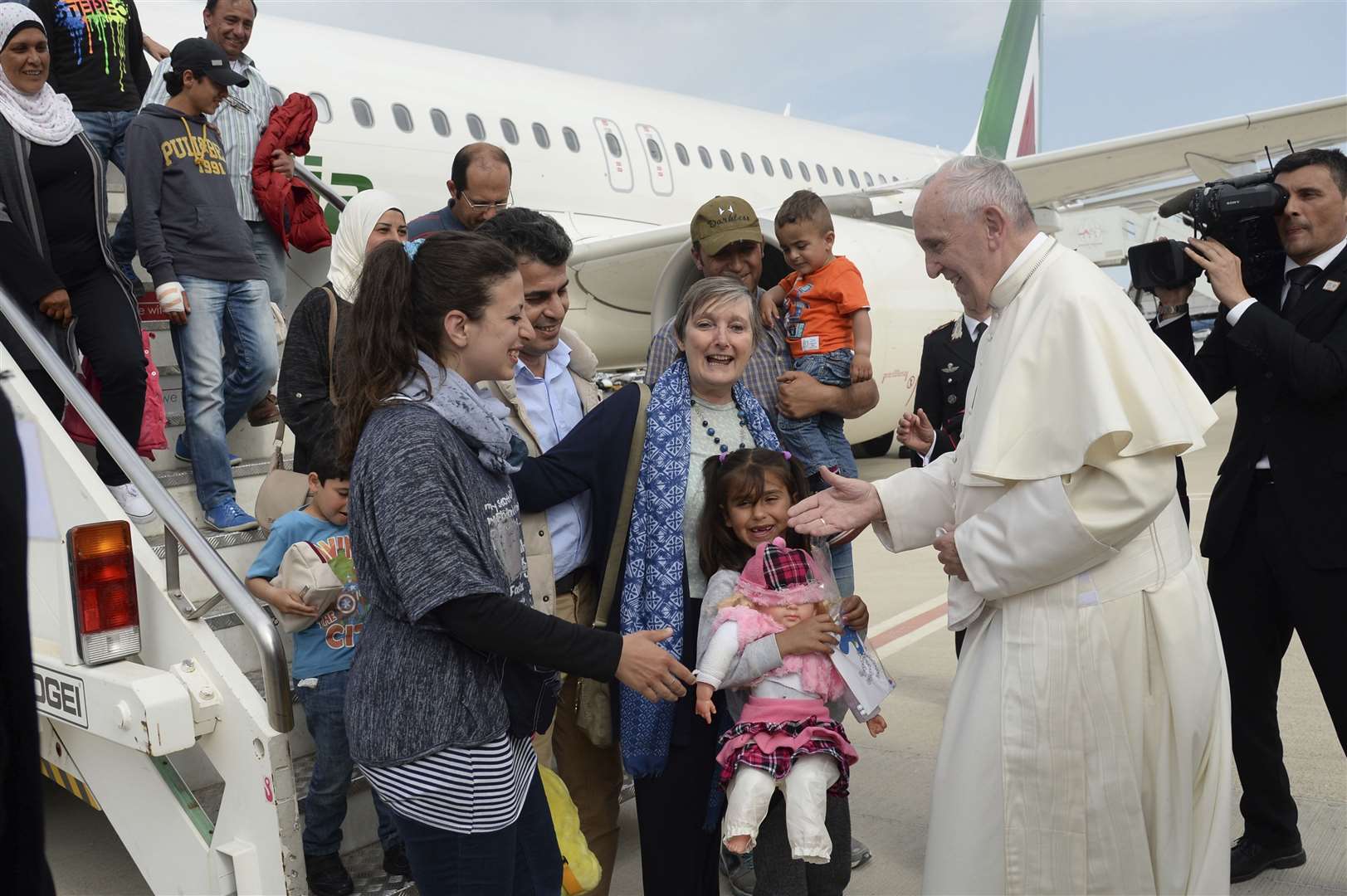 The Pope with a group of Syrian refugees who arrived in Italy with the pontiff’s charter plane after his visit to the Greek island of Lesbos in 2016 (Filippo Monteforte/Pool Photo via AP)