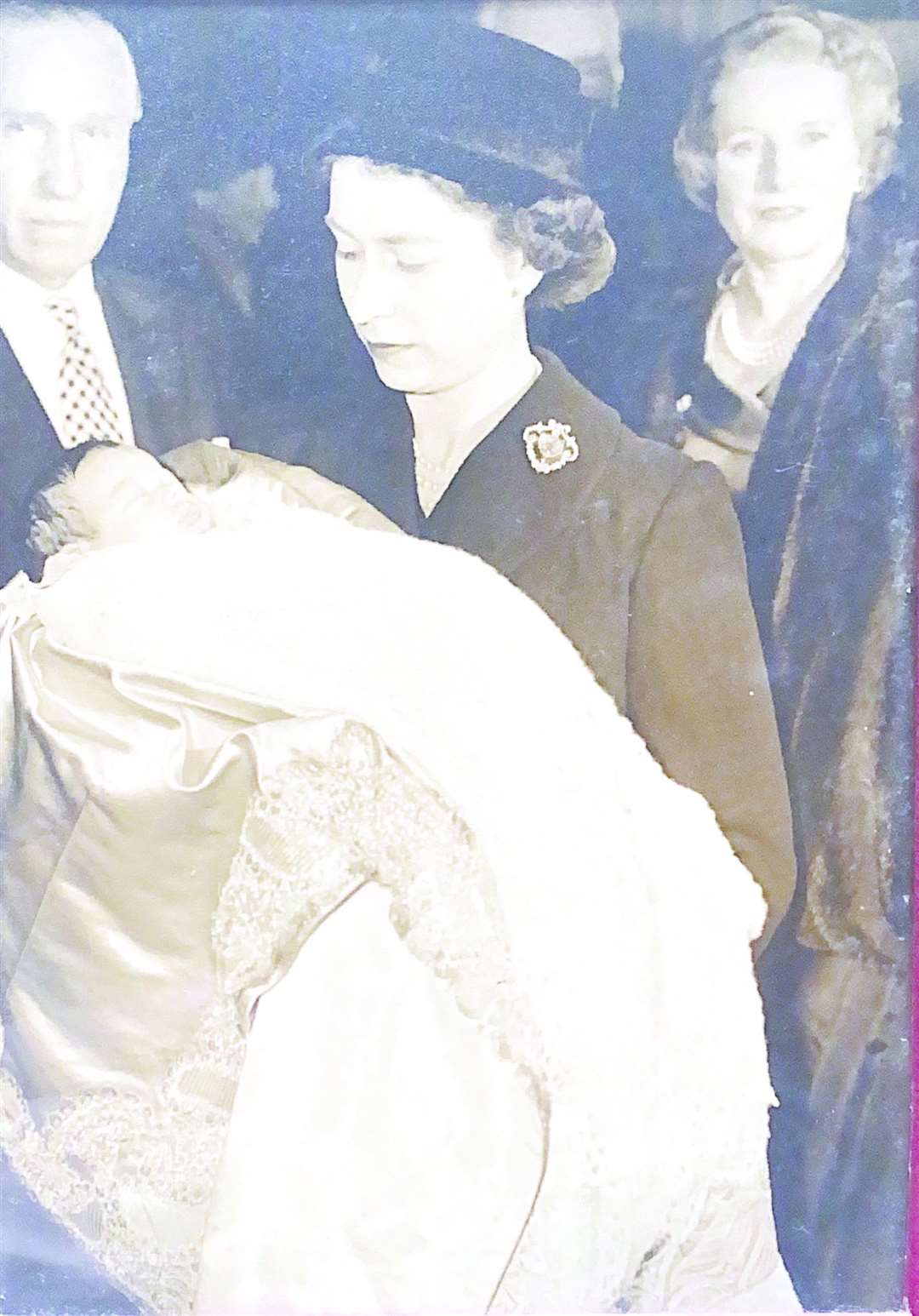 The Queen holds a young Earl of Carnarvon at his Christening
