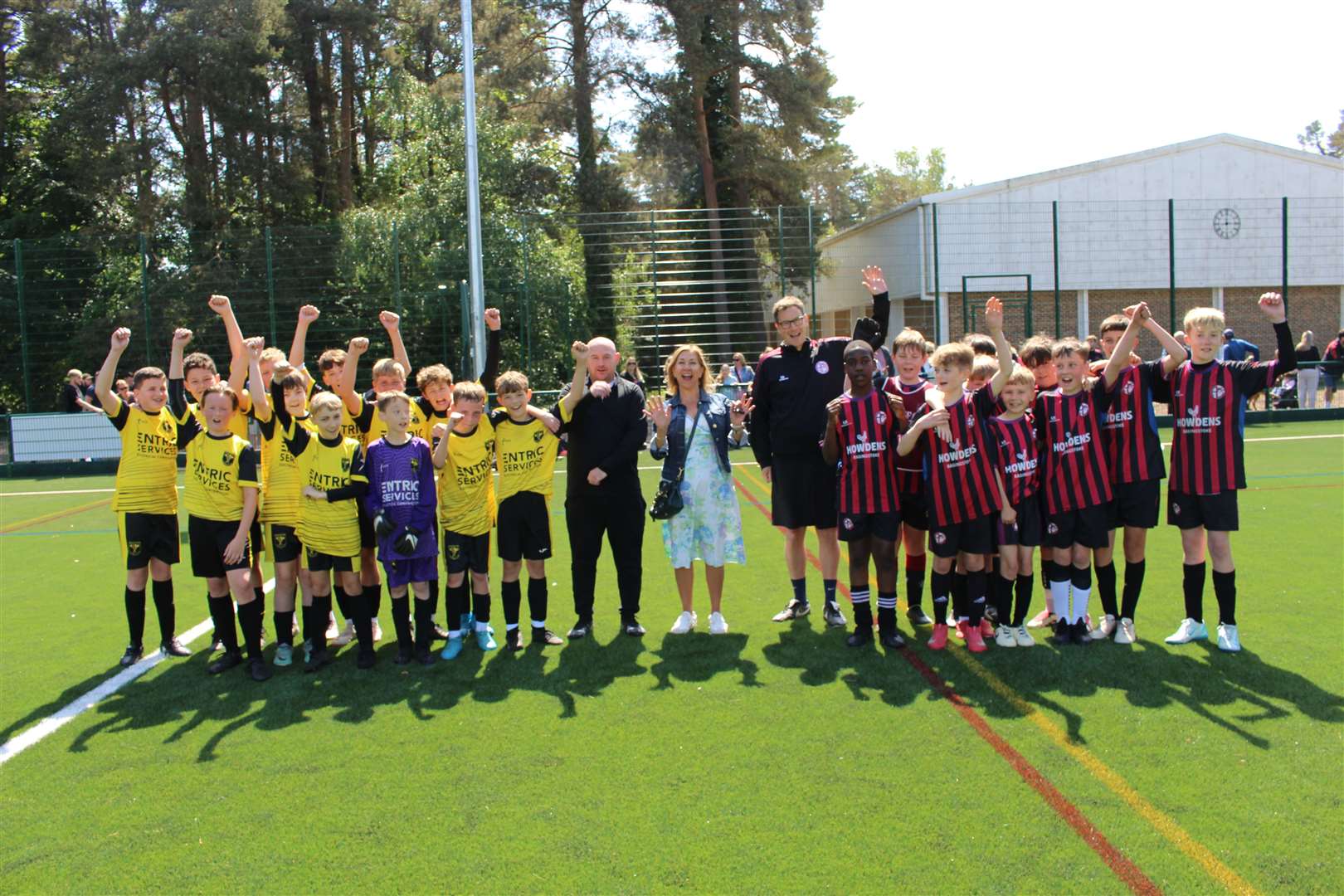Tadley and Calleva FC and Aldermaston FC players and coaches on the 3G pitch with The Hurst School headteacher, Jayne McLaren