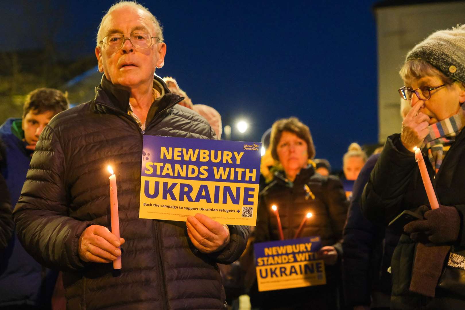 The signs were handed out last Friday at the candlelit vigil