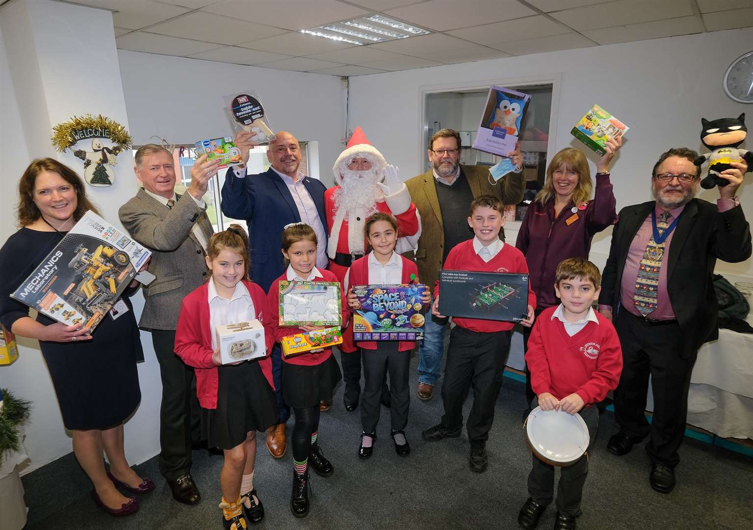 The Louise Purton Christmas Toy Appeal: Parsons Down headteacher Catherine Bull , West Berkshire deputy chairman Cllr Rick Jones, Swift Group managing director Adrian Smith, Father Christmas, Community Furniture Project CEO Kelvin Hughes, Carol Irwin from Sainsbury's and Deputy Mayor of Newbury Cllr Gary Norman with Parson Down Pupils Ref: 46-1721