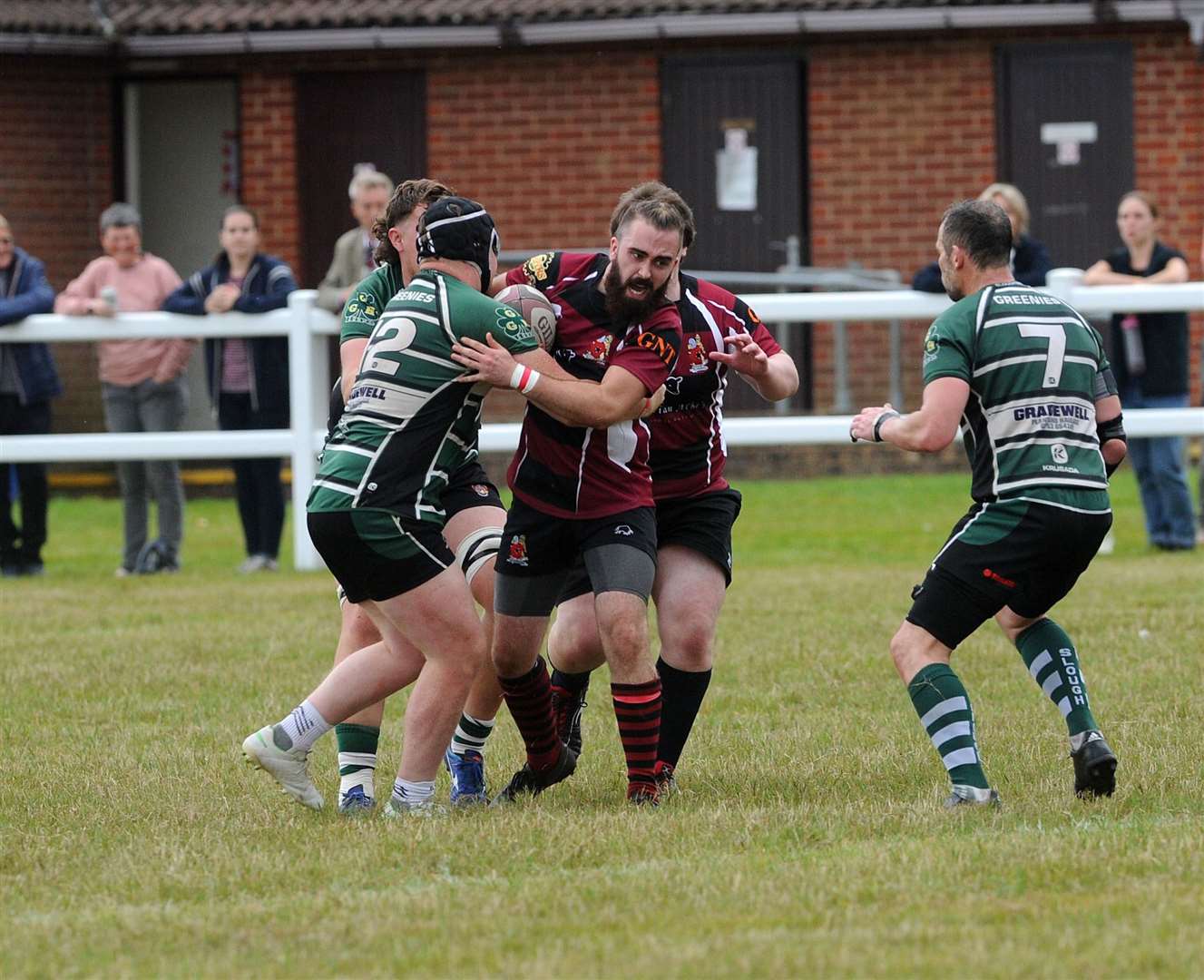 A Hungerford player attempts to hold onto the ball