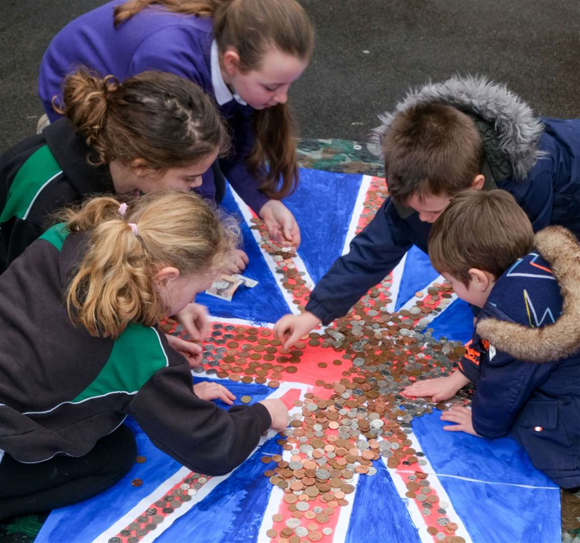 Pupils decorating a flag in aid of Little Troopers