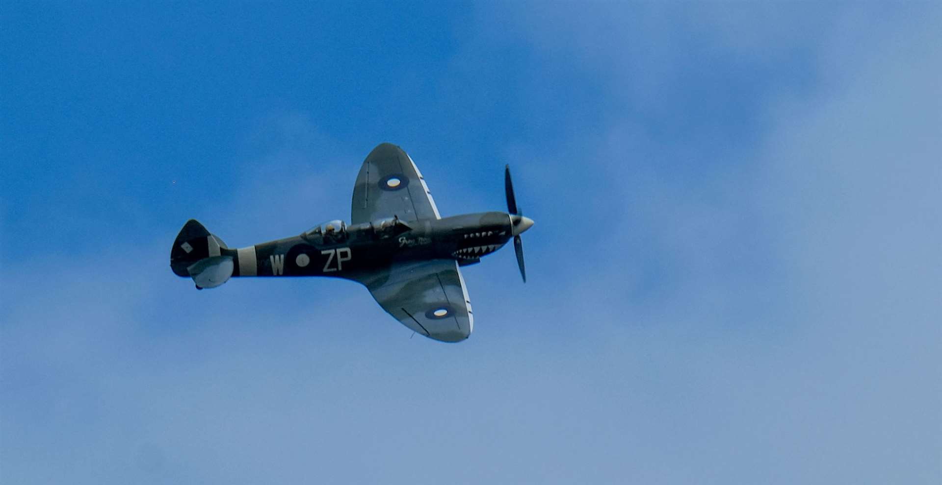 Spitfire flies over the old Quantel building in Newbury