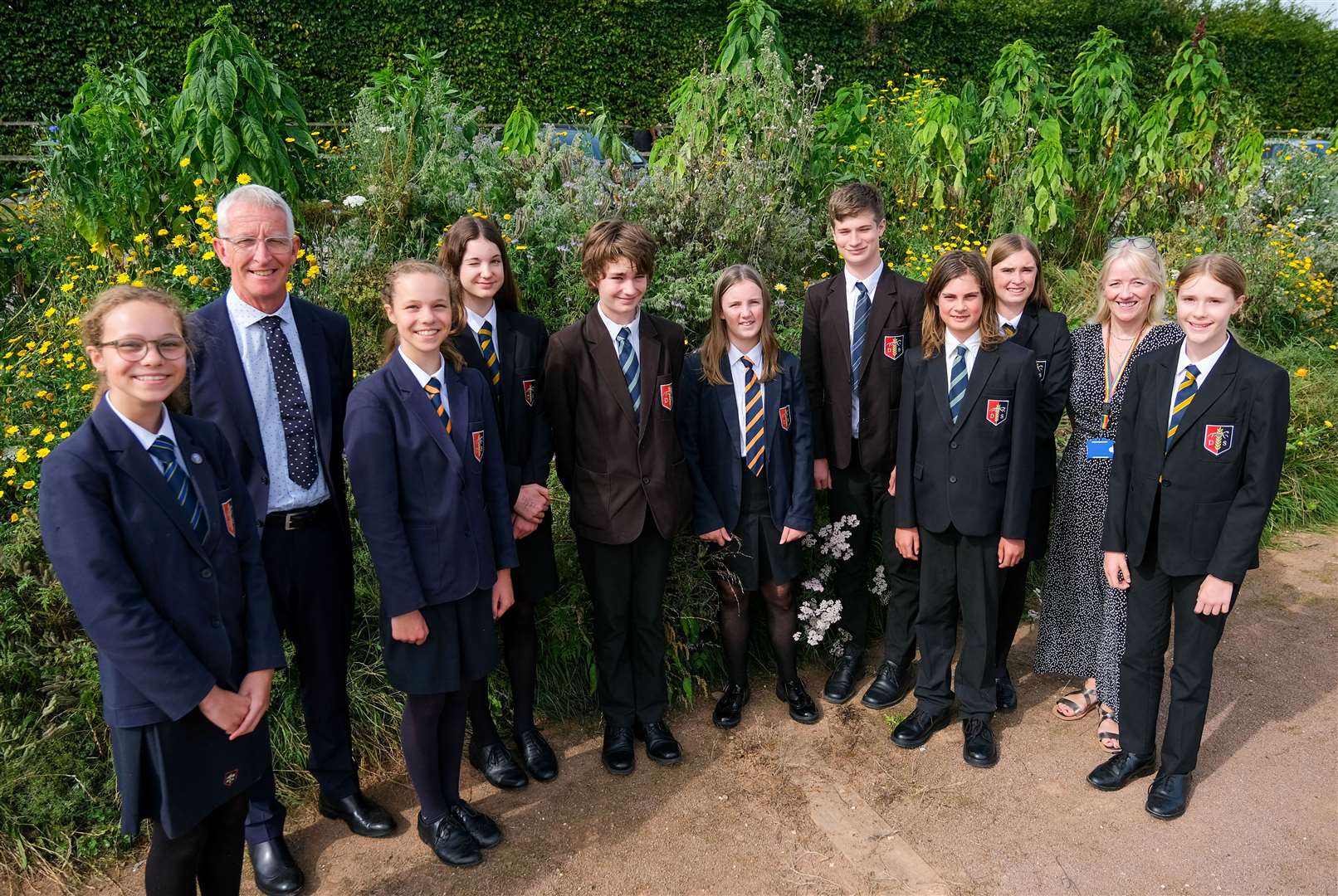 Headteacher, Chris Prosser, and head of geography, Helen Hicks, with the eco team in the green area