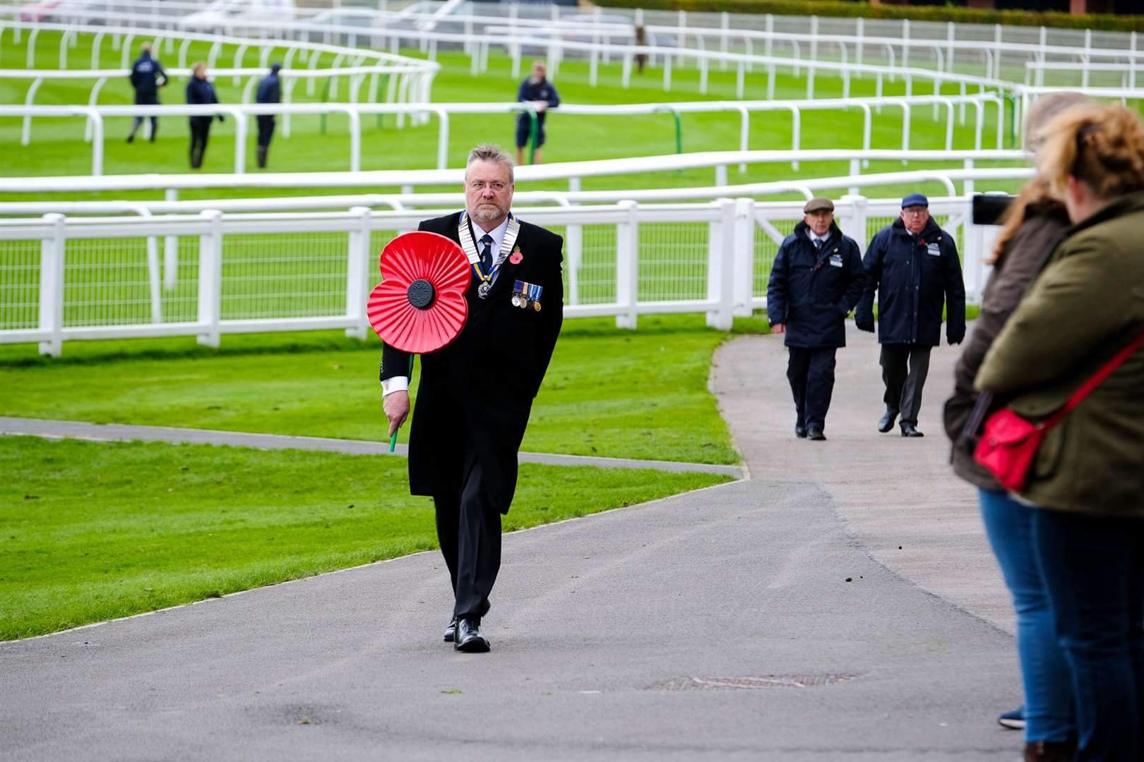 Major Jim Sibbald makes his way to the Royal Box with the poppy