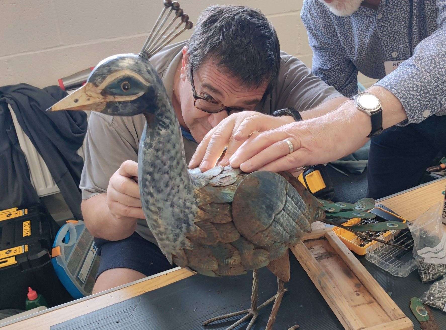 Model peacock being repaired