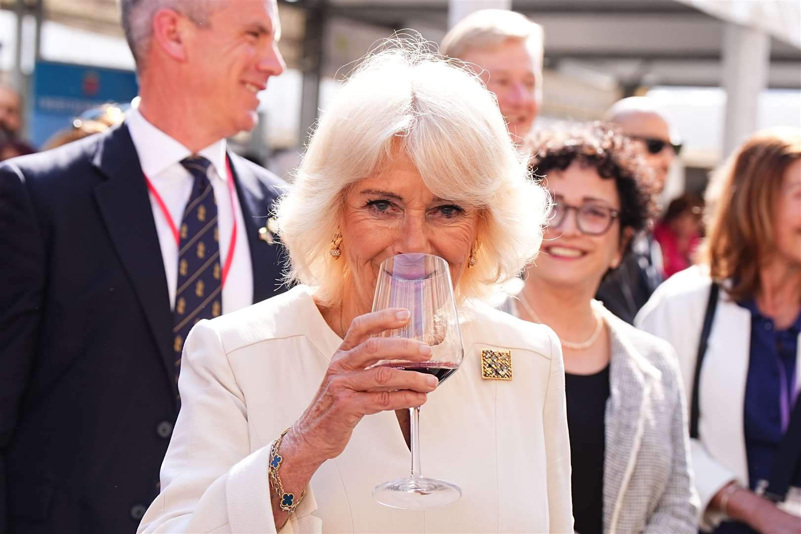 Camilla drinks a glass of red wine at Piazza del Popolo in Ravenna (Aaron Chown/PA)