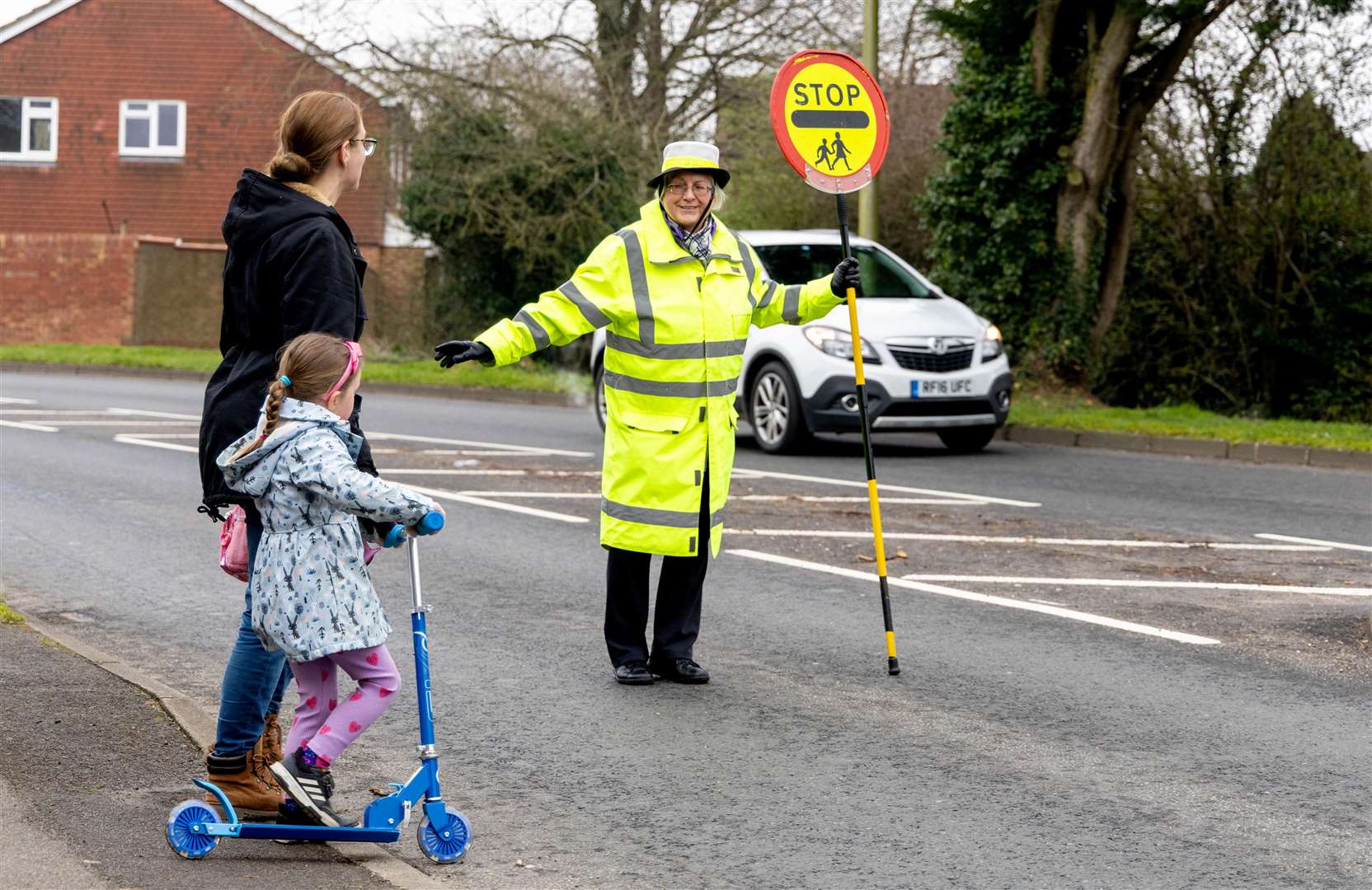 Jenny helping a family to cross the road