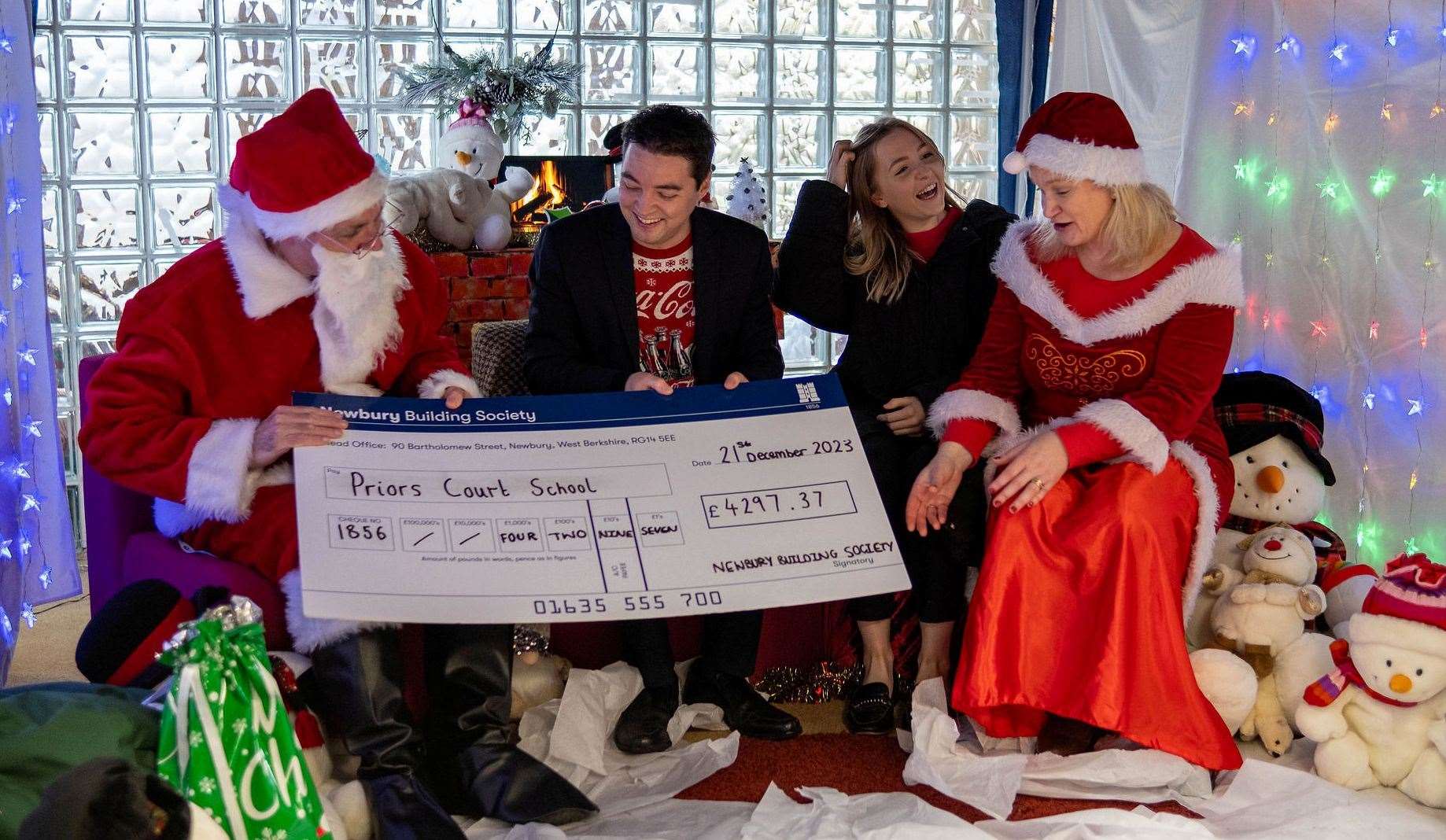 Matthew Wilding and Molly MacLean from Newbury Building Society in Santa’s Grotto with ‘Santa and Mrs Claus’. Credit: Michael Harden