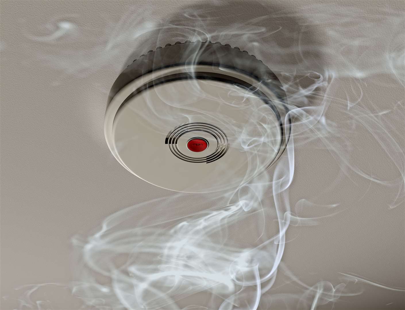 Illustration of a smoke alarm sounding off in a smoky room.