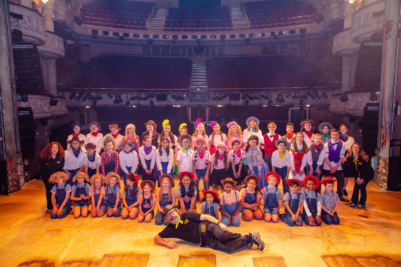 Staff and students of PQA Reading pose inside the Shaftesbury Theatre, London. Credit: Danny Kaan