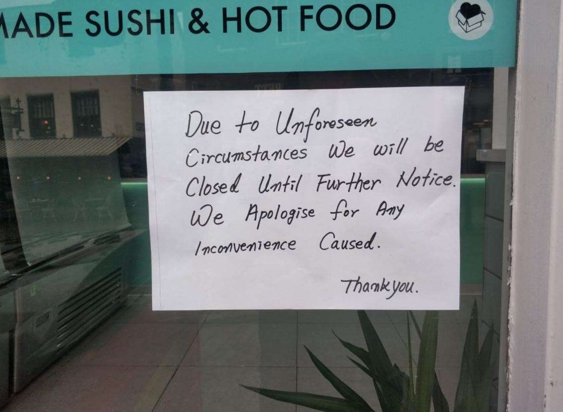 A sign on the door says the store will be closed until further notice. (54216689)