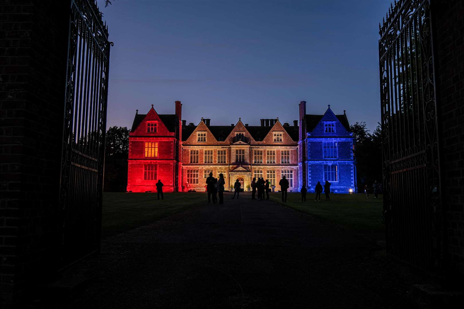 Shaw House lit up in red, white and blue