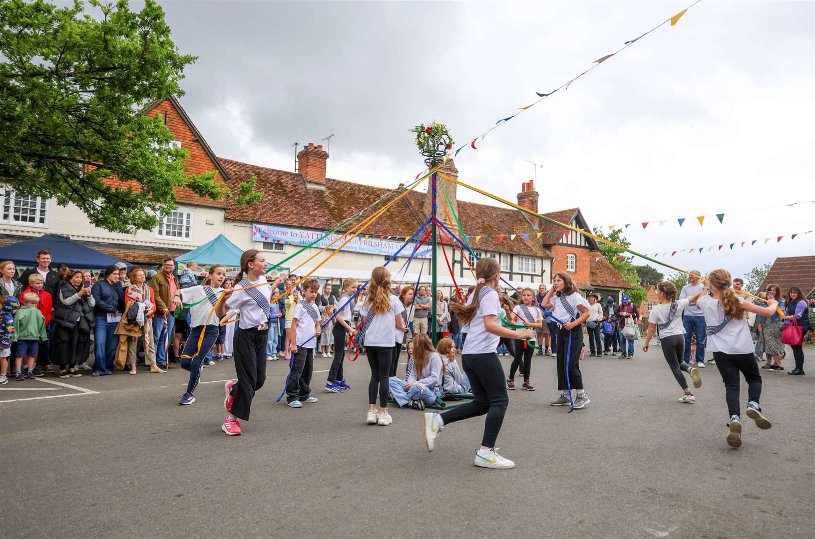 Children from Yattendon Primary School dancing around the maypole