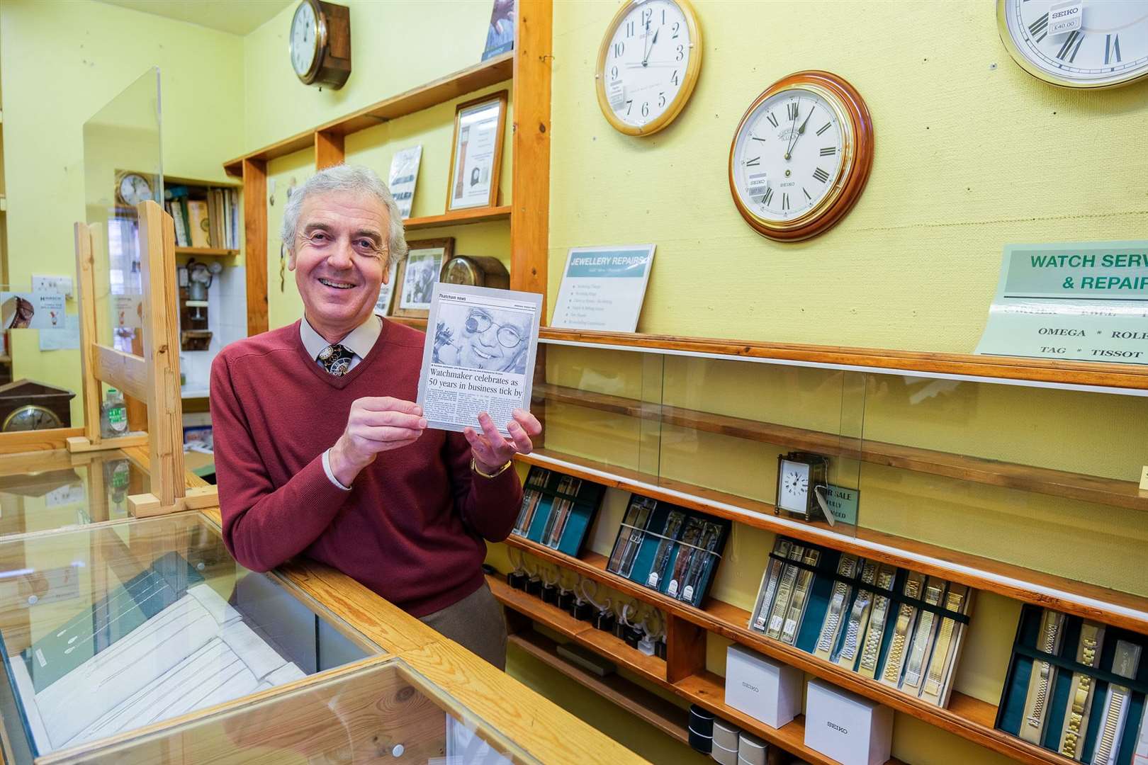 Dave Drummond with a cutting of the Newbury Weekly News recognising 50 years of his fathers time with the business