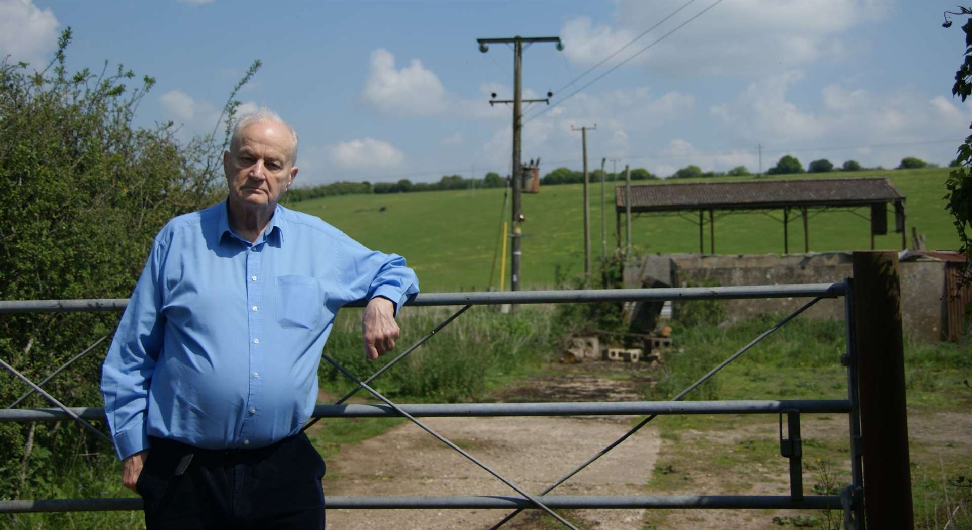 John Duffield standing outside the proposed development site, currently occupied by disused agricultural buildings. Credit: Adam Smith