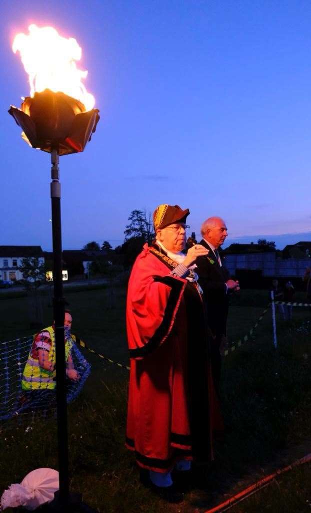 Mayor of Thatcham Jeff Brooks with the lit beacon for the Queen's Platinum Jubilee at Dunstan Green, Thatcham