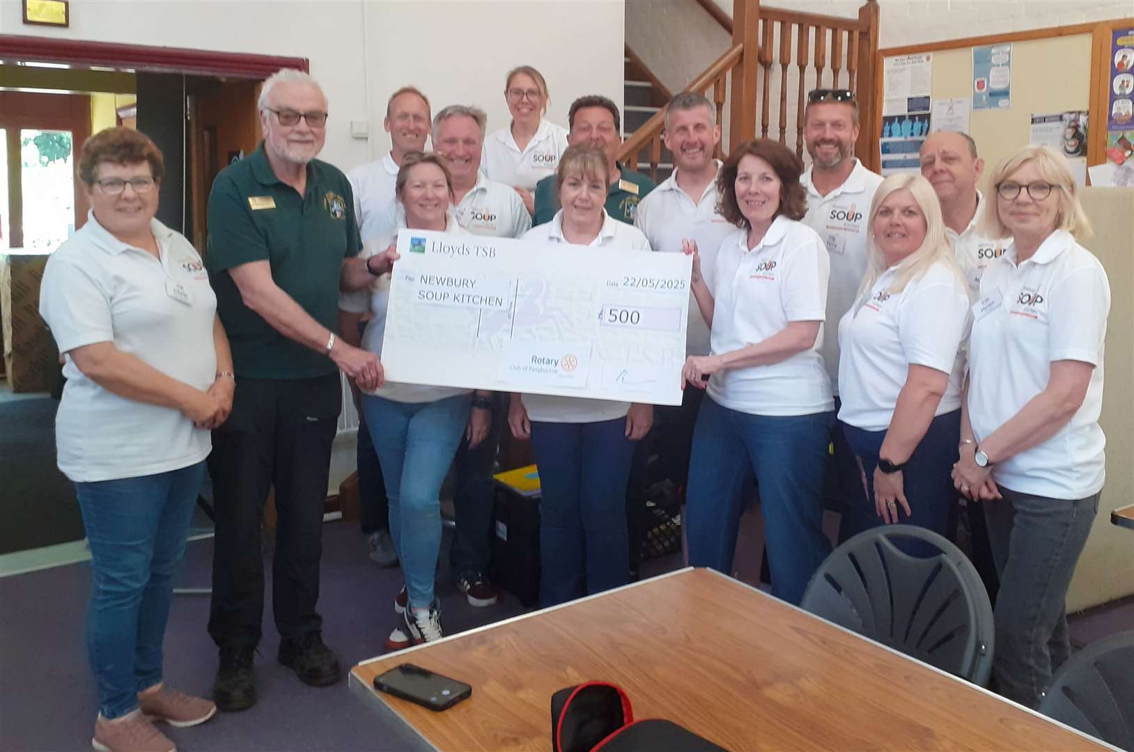 Rotarians Brian Davies and Mal Sandham presenting cheque to Meryl Praill and her staff at Newbury Soup Kitchen