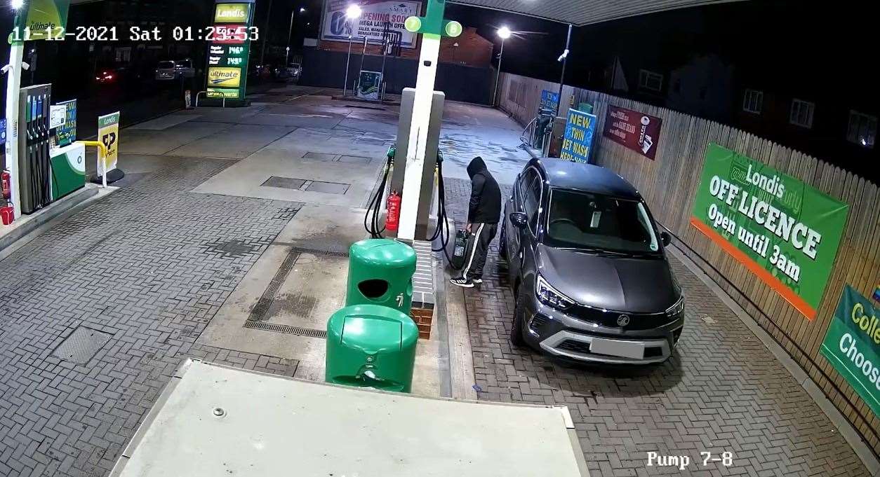 Mr Kigundu filling up a container at BP garage on Oxford Road, Reading. Picture: TVP