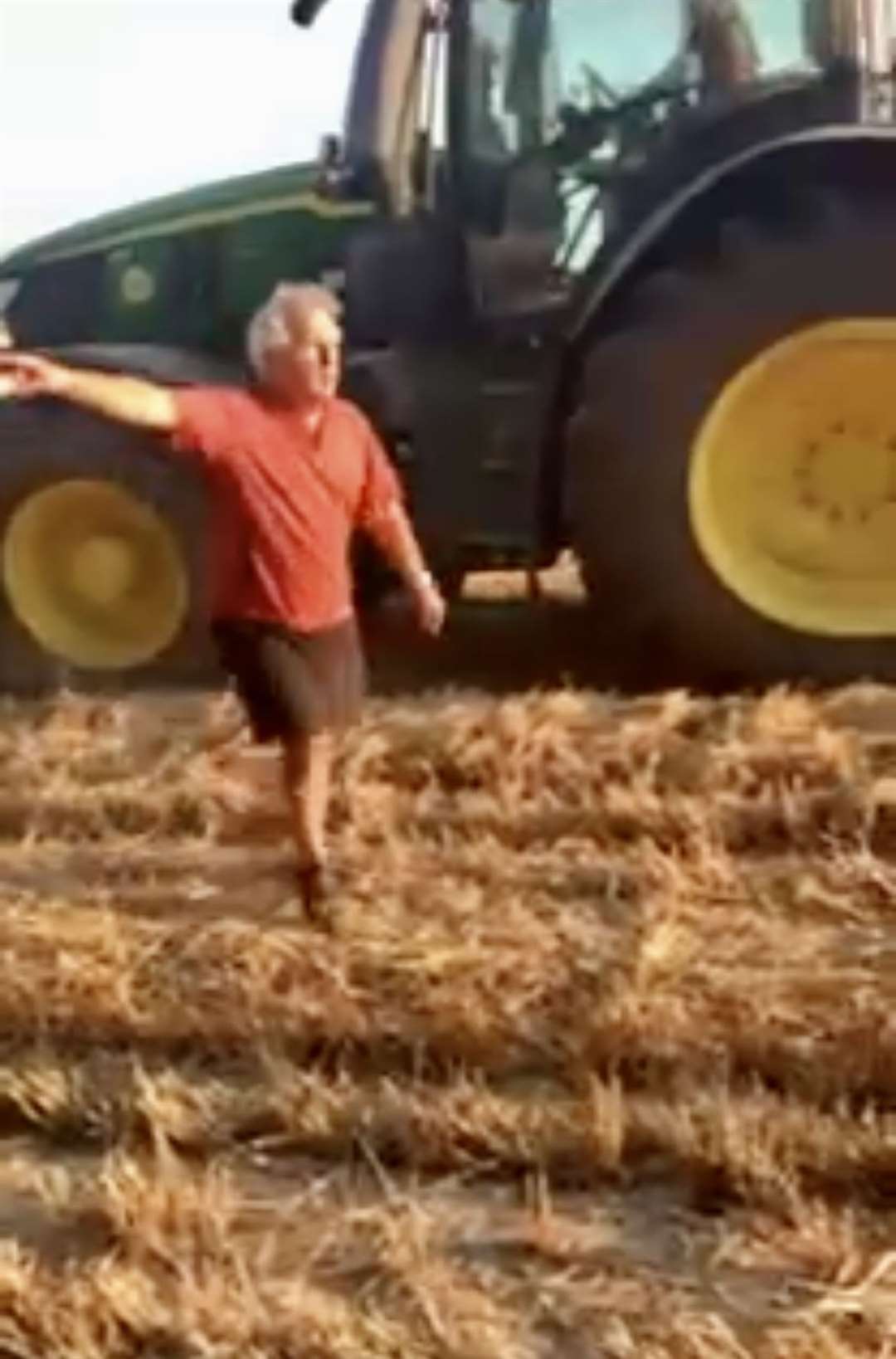 Angry picnicker tries to stop combine harvester