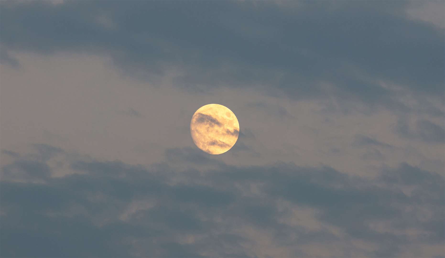 August Sturgeon Full Moon hides behind blue clouds