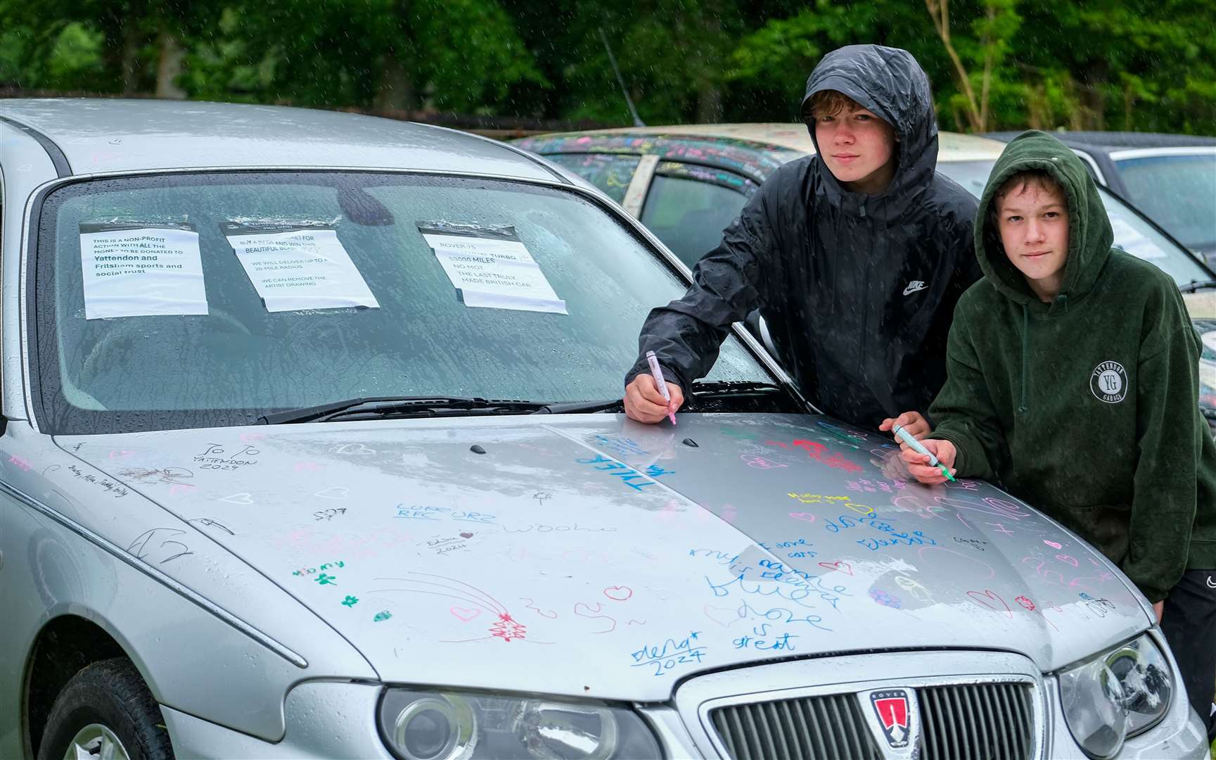 Max and Alex write on the car