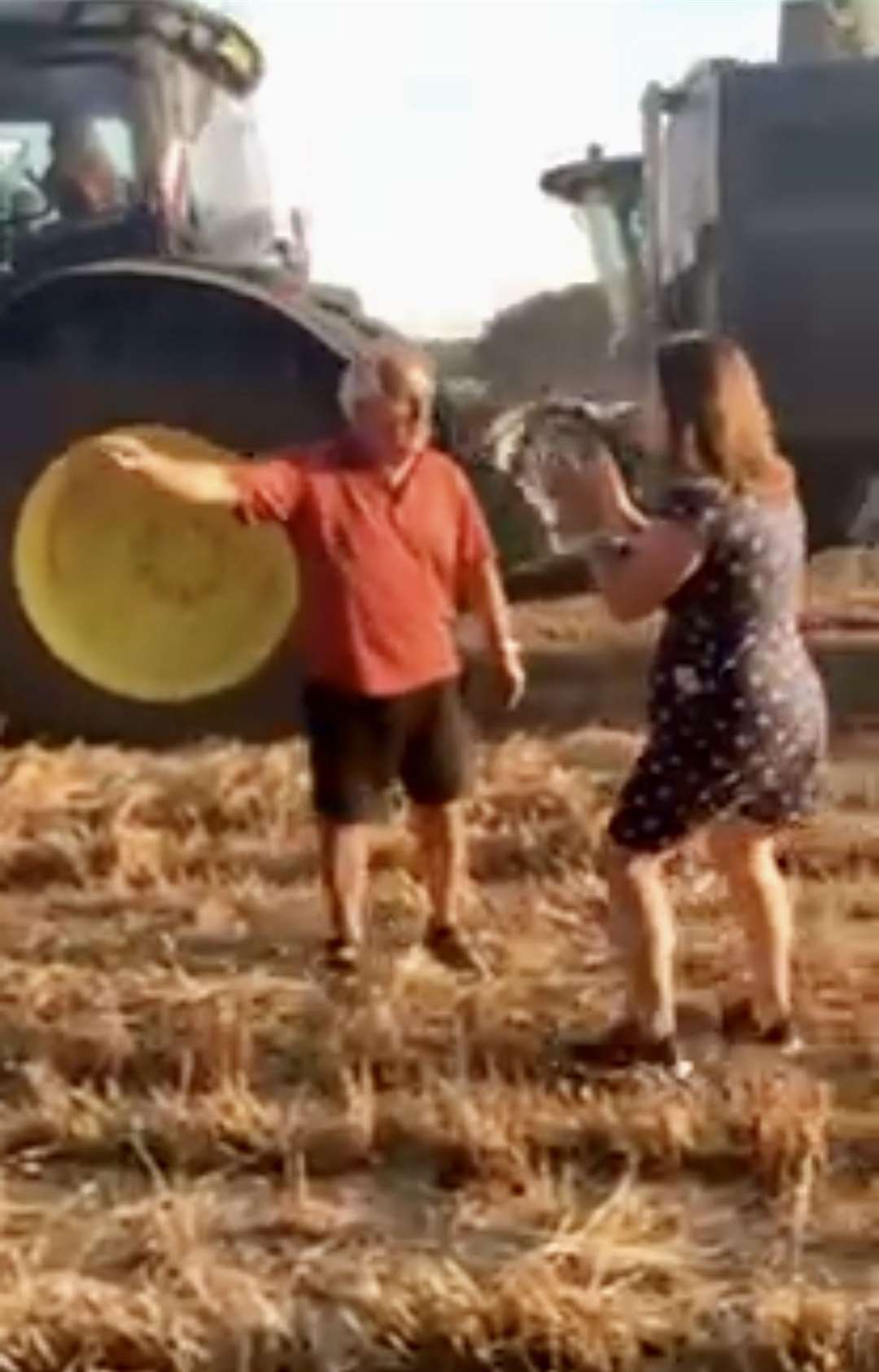 Angry picnicker tries to stop combine harvester