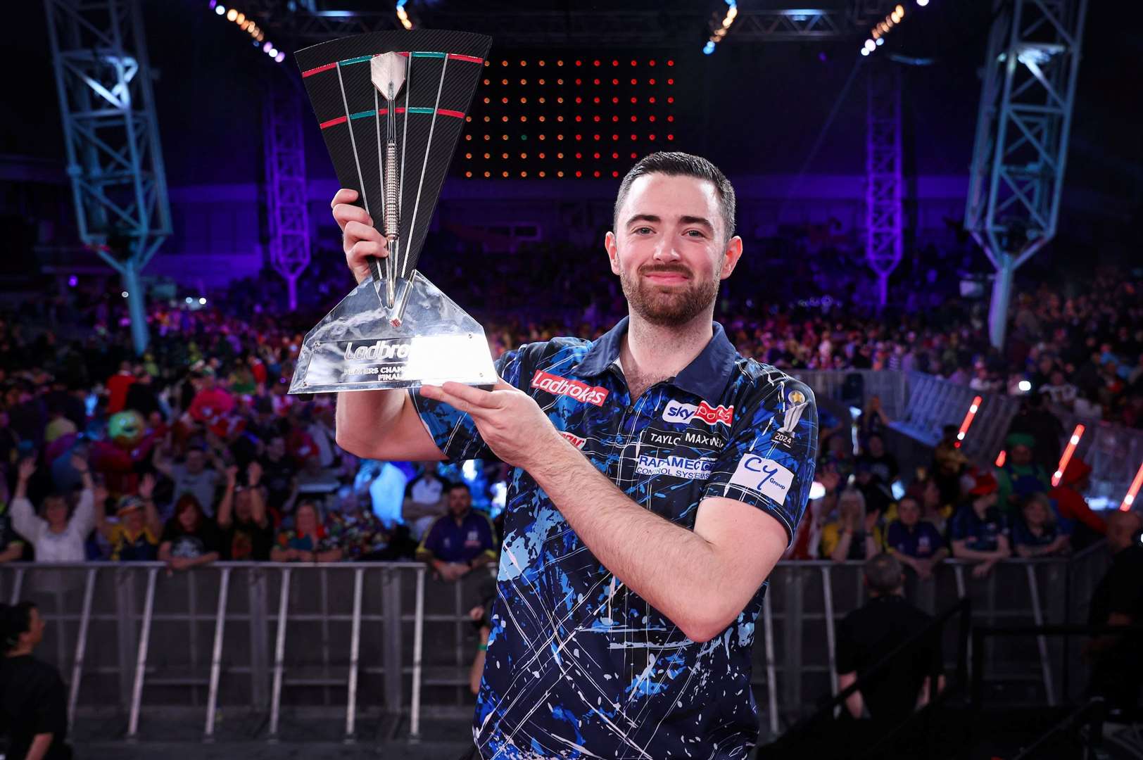 Luke Humphries celebrates retaining the Players Championship, after defeating Luke Littler - Photo: Kieran Cleeves/PDC