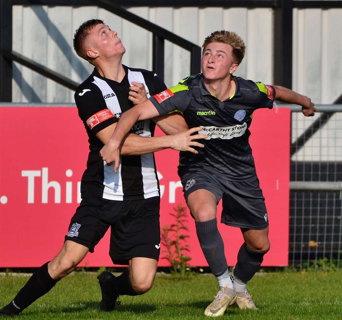 Two players fight for the ball